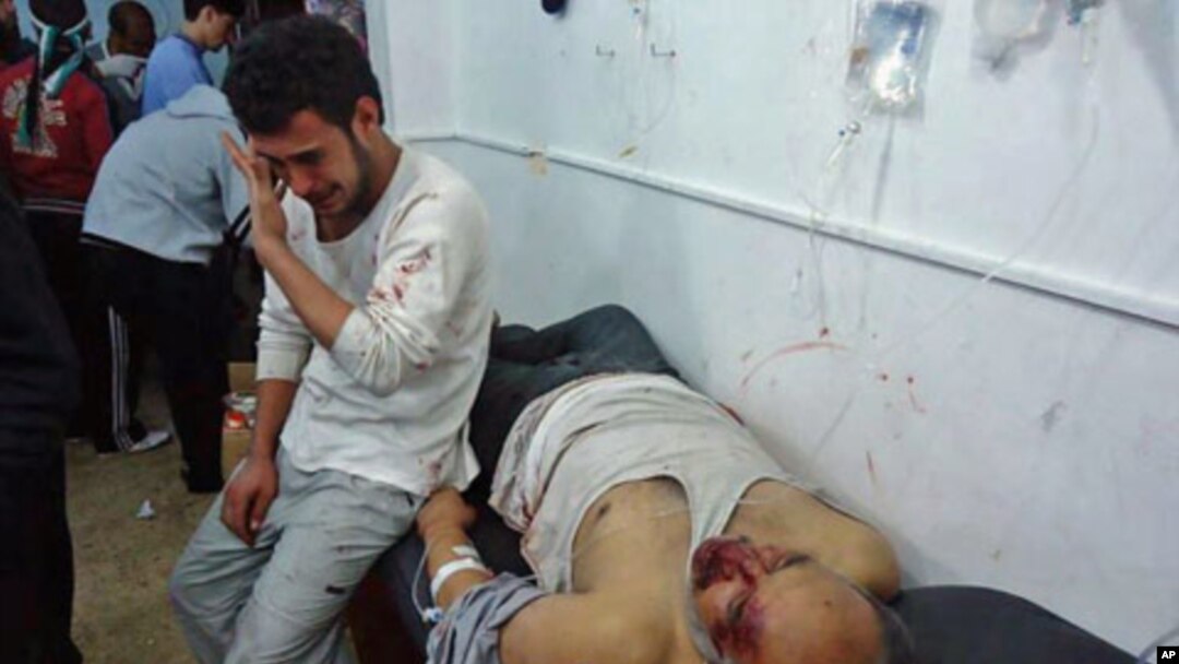 Wounded men are seen in the Sunni Muslim district of Baba Amr in Homs, Syria, February 8, 2012.