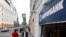 People walk past an office of Gazprombank, Russia's third-largest bank, in Moscow, July 17, 2014. 