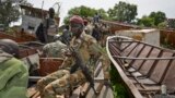 FILE - a government soldier travels from Renk across the Nile to the front line garrison town of Kuek, to patrol the border, in northern Upper Nile state, South Sudan.