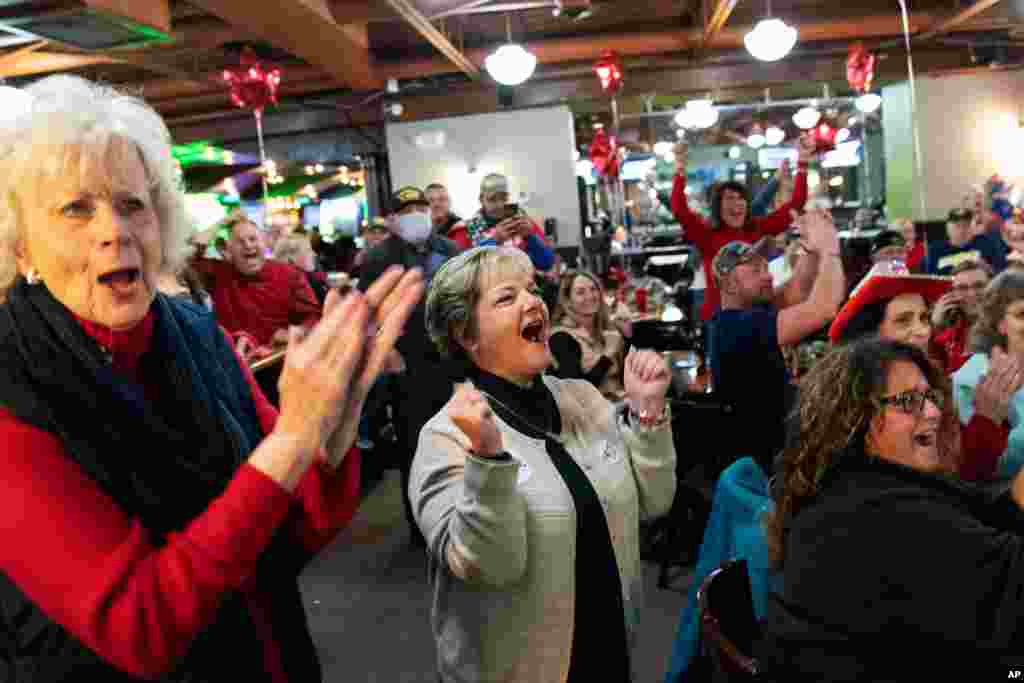 Supporters of President Donald Trump cheer while watching election results at a watch party in Shelby Township, Michigan, Nov. 3, 2020.