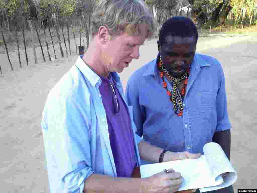 Adjudicators consulting during the mud hut decoration competition in Matobo, Matabeleland South Province, Zimbabwe