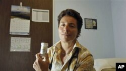 Dr. Lisa Sterman holds a bottle of Truvada pills that she prescribes for patients at high risk for developing AIDS in San Francisco.