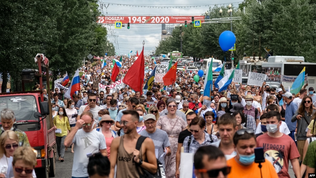 People hold banners and signs during an unauthorised rally in support of Sergei Furgal, the governor of the Khabarovsk region who was arrested, in the Russian far eastern city of Khabarovsk on July 25, 2020.