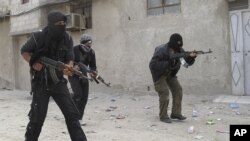 Free Syrian Army fighters train in a neighborhood of Damascus, Syria