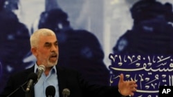 FILE — Yahya Sinwar, head of Hamas in Gaza, delivers a speech during a meeting with people at a hall on the sea side of Gaza City, April 30, 2022.