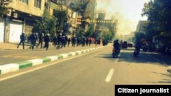 A user generated photo appears to show riot police following protesters down Saadi Street in Tehran. Via Saeed Valadbaygi on TwitPic