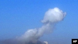 Smoke billows from the site of a blast in Tajura, a suburb of the Libyan capital Tripoli, on May 15, 2011 after several loud explosions shook east of the capital and columns of smoke rose into the sky in many locations.