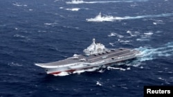 FILE - China's Liaoning aircraft carrier with accompanying fleet conducts a drill in an area of South China Sea, in this photo taken December 2016.