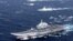 FILE - China's Liaoning aircraft carrier with accompanying fleet conducts a drill in an area of South China Sea, in this photo taken December 2016.