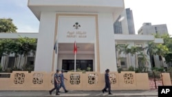 FILE - Policemen patrol near the Parliament building in Male, Maldives, Nov. 5, 2015.