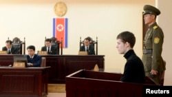 U.S. citizen Matthew Todd Miller (2nd R) sits in a witness box during his trial at the North Korean Supreme Court in Pyongyang, September 14, 2014.