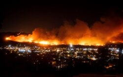 FILE - Smoke from the Maria Fire billows above Santa Paula, Calif., Oct. 31, 2019. The state's largest utility initiated multiple rounds of pre-emptive power outages.
