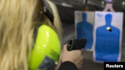 A shell casing ejects from a gun fired during a meeting of the Well Armed Woman Shooting chapter at GAT Guns' shooting range in East Dundee, Ill., April 21, 2015. 