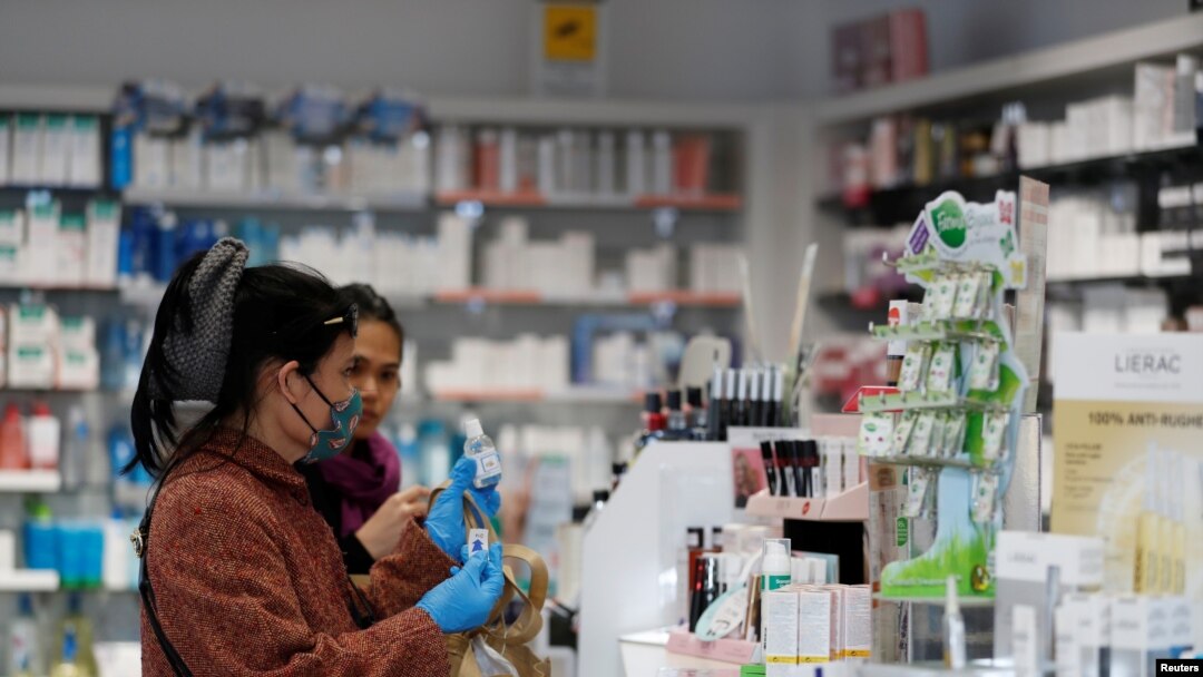 Women buy a hand sanitizer at a pharmacy in Milan, Italy, Feb. 26, 2020.