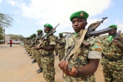 FILE - Burundian African Union Mission in Somalia (AMISOM) peacekeepers stand in formation during a ceremony as they prepare to leave the Jaale Siad Military academy after being replaced by the Somali military in Mogadishu, Somalia, Feb. 28, 2019.