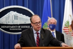 FILE - Acting Assistant U.S. Attorney General Jeffrey Clark speaks as he stands next to Deputy Attorney General Jeffrey Rosen during a news conference at the Justice Department in Washington, Oct. 21, 2020.