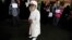 A man stands near supporters of Muslim Brotherhood and ousted Egyptian President Mohamed Morsi as they shout slogans against the military and the interior ministry during a protest in front of Al Tawheed mosque in Cairo, August 23, 2013.