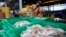 Migrant workers separate freshly caught fish by size at a fish market in Samut Sakhon Province, west of Bangkok, June 20, 2014.