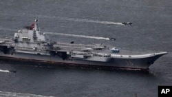 FILE -China's aircraft carrier Liaoning sails into Hong Kong to celebrate the 20th anniversary of the People's Liberation Army garrison's presence in the city on July 7, 2017. 