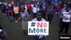 People sing as they attend a memorial concert in Kenya's capital Nairobi, April 14, 2015, in memory of the victims of the deadly Garissa University College attack in early April.