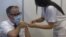 Kosovo, Pristina, Arben Vitia health ministar getting vaccinated