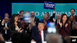 FILE - The crowd cheers as Republican presidential nominee former President Donald Trump participates in a roundtable with Latino leaders, in Doral, Florida, Oct. 22, 2024.