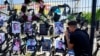 A person mourns as he embraces the picture of his loved one killed at a soccer pitch by a rocket Israel says was fired from Lebanon, in Majdal Shams, a Druze village in the Israeli-occupied Golan Heights, July 29, 2024. 