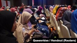 Queenrides women members take part in a workshop in Indonesia. 