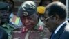 FILE - Zimbabwe's President Robert Mugabe, right, talks to General Constantine Chiwenga upon his arrival at Harare International Airport, July 4, 2008.