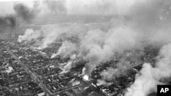 FILE - In this April 5, 1968 file photo, buildings burn along H Street in the northeast section of Washington, set afire during a day of demonstrations and rioting in reaction to the assassination of Dr. Martin Luther King Jr. 