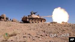 This frame grab from video provided by the Lebanese Army official website, a Lebanese army tank fires during a battle against Islamic State militants, on the outskirts of Ras Baalbek, northeast Lebanon, Aug. 20, 2017. 