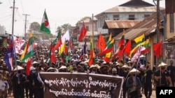 Protesters holding a banner and flags take part in a demonstration against the military coup on "Global Myanmar Spring Revolution Day" in Kyaukme in Myanmar's Shan State, May 2, 2021. (Credit: Shwe Phee Myay News Agency)
