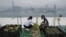 In this Nov. 14, 2017 photo, Michelle Hong, right, and Catherine Ng wash lettuce on the roof of the 38-story Bank of America tower, in Hong Kong. 