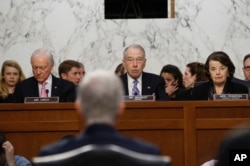 Supreme Court Justice nominee Neil Gorsuch, back to camera, listens on Capitol Hill in Washington, March 21, 2017, as Senate Judiciary Committee Chairman, Republican Senator Charles Grassley, flanked by colleagues, speaks on Capitol Hill in Washington, March 21, 2017.