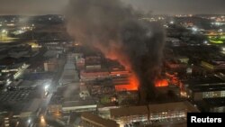 FILE - Smoke rises from a burning building amid a deadly fire, in Johannesburg, South Africa, August 31, 2023, in this image obtained from social media. (X/@odirileram/via REUTERS)