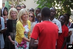 FILE - Jill Biden, second left, the wife of U.S. Vice President Joe Biden, shakes the hand of a former child soldier in Bukavu, Democratic Republic of Congo, July 5, 2014. Jill Biden is currently on her fifth trip to Africa.
