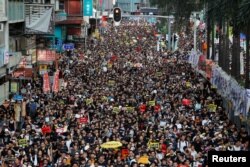 Anti-extradition bill protesters march during the anniversary of Hong Kong's handover to China in Hong Kong, China July 1, 2019. REUTERS/Tyrone Siu