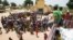 FILE - People queue for food aid distribution delivered by the United Nations Office for the Coordination of Humanitarian Affairs and world food program in the village of Makunzi Wali, Central African Republic, April 27, 2017.