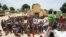 FILE - People queue for food aid distribution delivered by the United Nations Office for the Coordination of Humanitarian Affairs and world food program in the village of Makunzi Wali, Central African Republic, April 27, 2017.