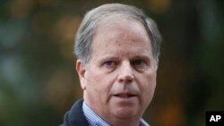 FILE - In this Dec. 4, 2017, file photo, then-Democratic senatorial candidate Doug Jones speaks at a news conference in Dolomite, Ala. Jones, the first Alabama Democrat elected to the Senate in a quarter century, is one of two new members who will take the oath of office on the Senate floor at noon on Jan. 3, 2018. 