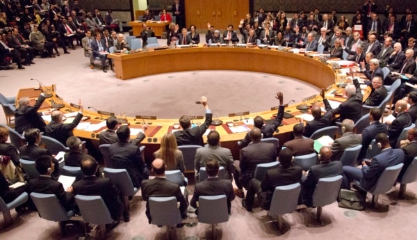 FILE - A gathering in the U.N. Security Council of foreign ministers lead by U.S. Secretary of State John Kerry vote on a draft resolution concerning Syria, at U.N. headquarters, Dec. 18, 2015.