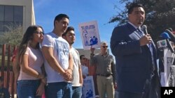 The family of Guadalupe Garcia de Rayos stands behind her attorney, Ray Ybarra Maldonado, as he speaks in front of the U.S. Immigration and Customs Enforcement office in Phoenix, Feb. 9, 2017.