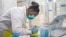 FILE - Medical scientist Melva Mlambo works at sequencing COVID-19 omicron samples at the Ndlovu Research Center in Elandsdoorn, South Africa, Dec. 8, 2021. 