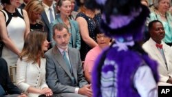 King Felipe VI and Queen Letizia of Spain, at left, watch Mardi Gras Indians perform during a cultural event at the New Orleans Museum of Art in New Orleans, June 16, 2018.