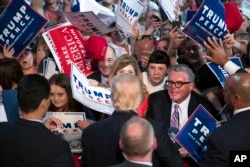 Supporters reach out for Republican presidential candidate Donald Trump during a campaign rally, July 27, 2016, in Toledo, Ohio.