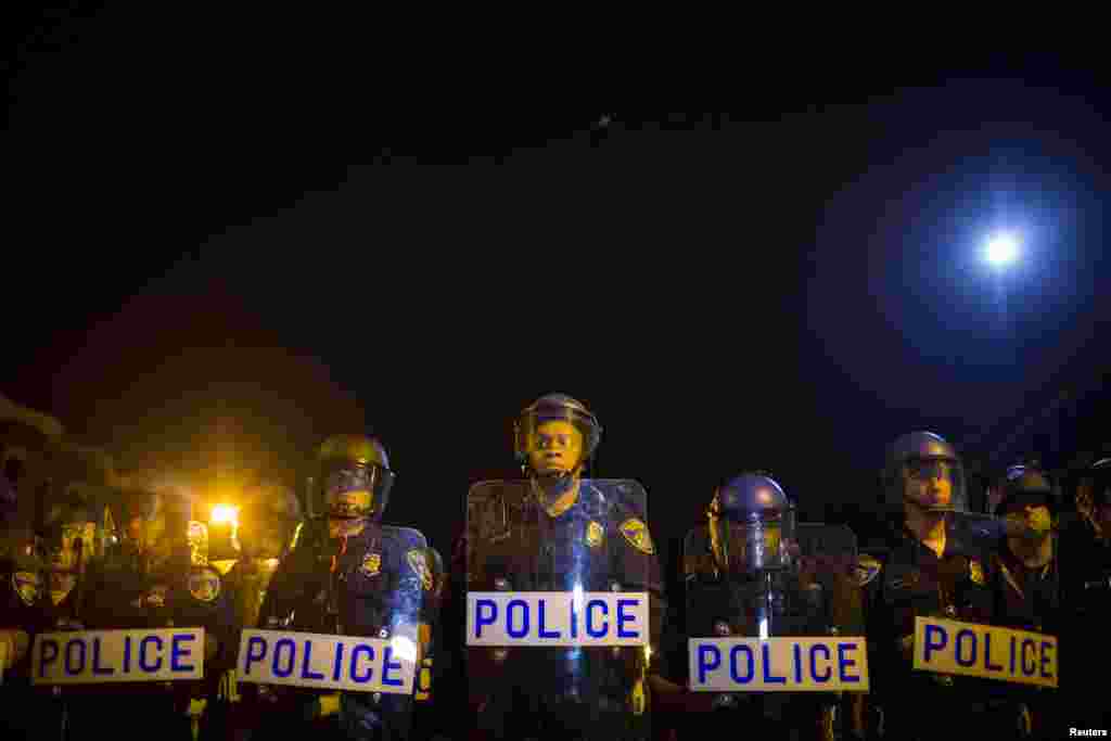 Police line up shortly after the deadline for a city-wide curfew at North and Pennsylvania Avenues in Baltimore, April 30, 2015.