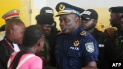 FILE - Former Kinshasa police chief, John Numbi, (C) walks into court,Jan. 27, 2011. Numbi was one of eight police officers accused of the death of a human rights activist in January 2010. 
