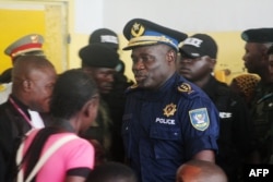 FILE - Former Kinshasa police chief, John Numbi, (C) walks into court on Jan. 27, 2011. Numbi was one of eight police officers accused of the death of human rights activist Floribert Chebeya in January 2010.