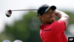 FILE - Tiger Woods hits from the third tee during the final round of the Cadillac Championship golf tournament.