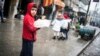 A child sells bread in the streets of Aleppo, Syria, January 5, 2013.